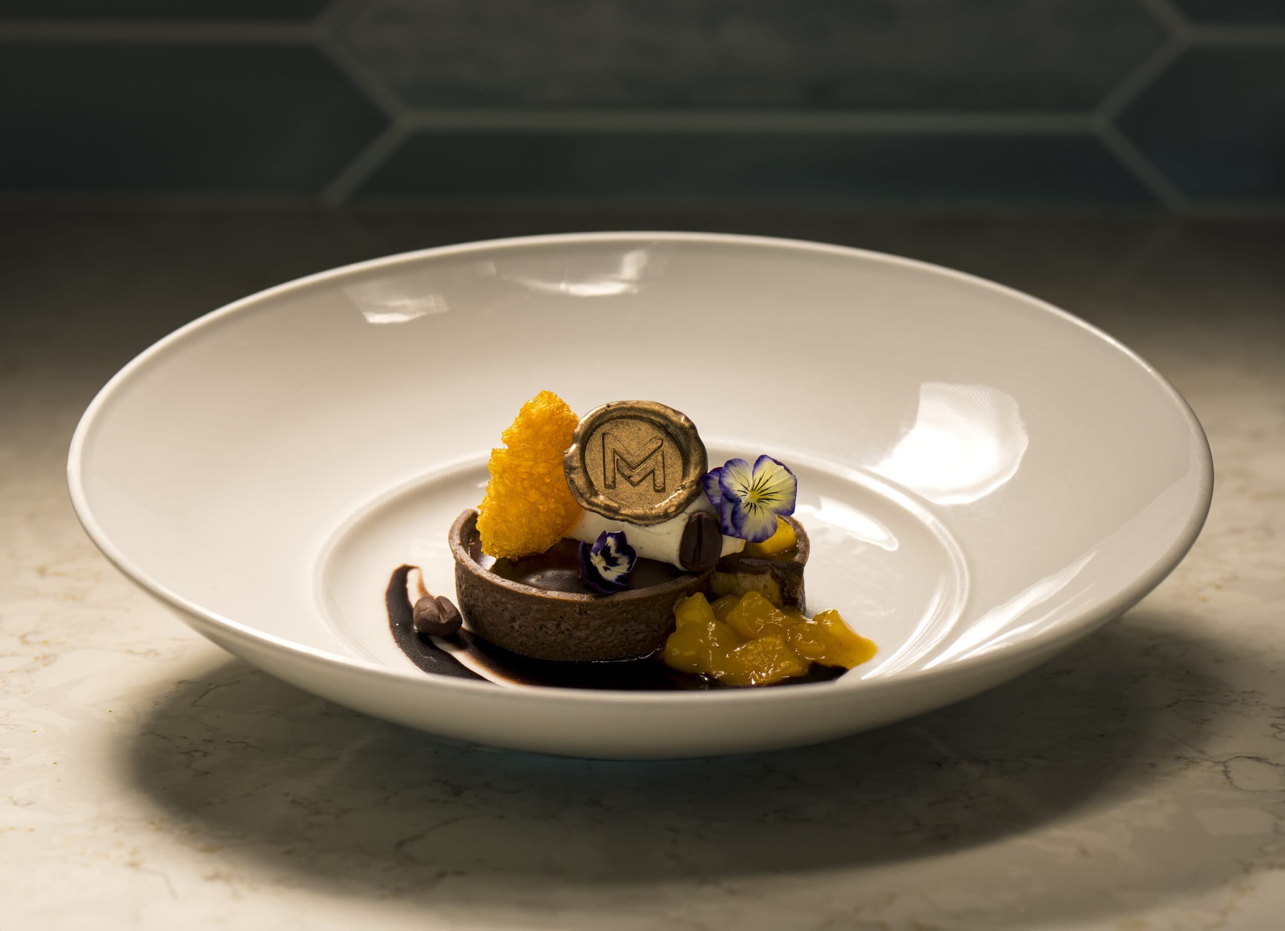 A gourmet dessert with fancy garnishes.